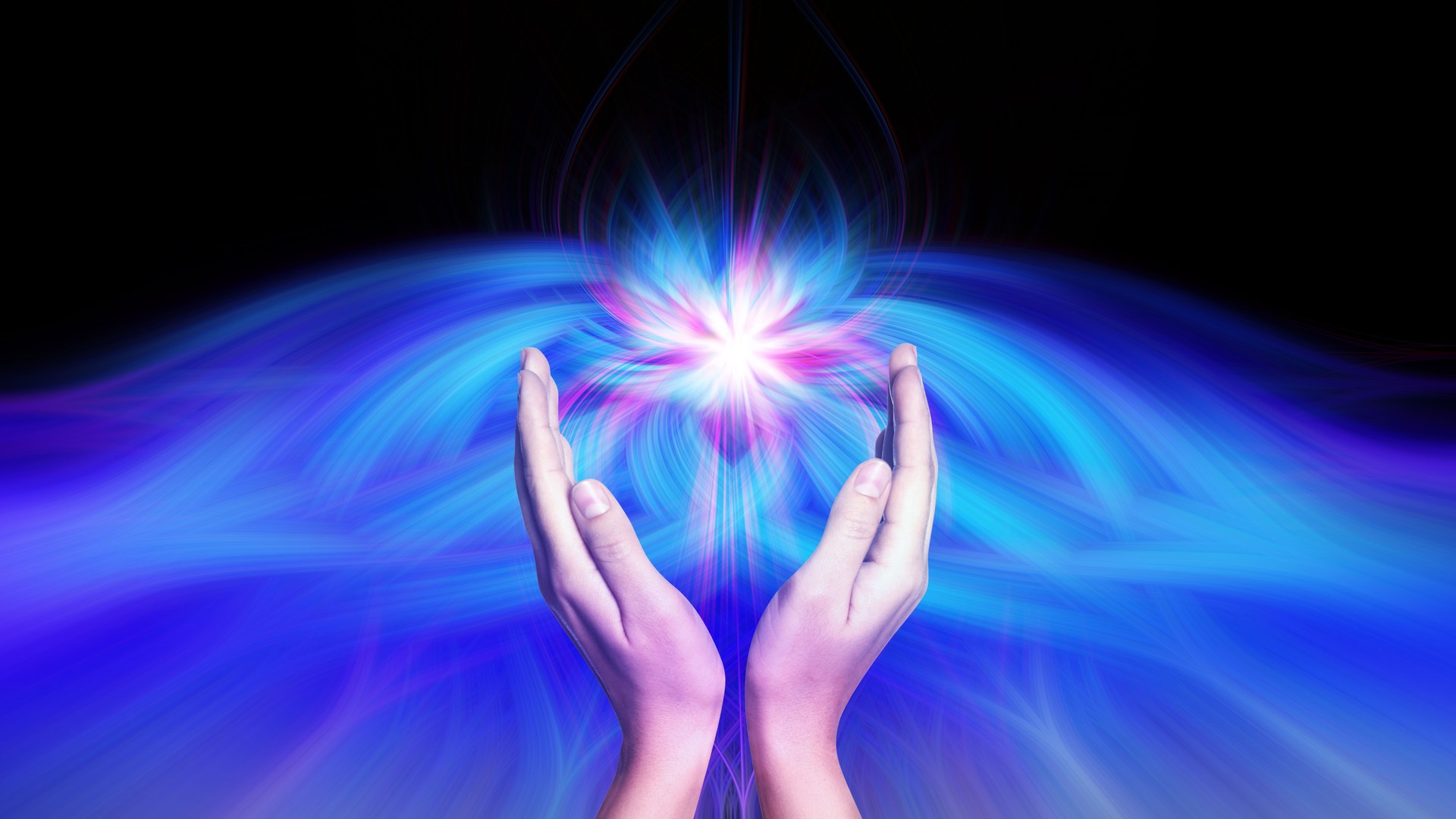Aura phenomena. Woman with flows of energy making beautiful pattern between her hands against black background, closeup